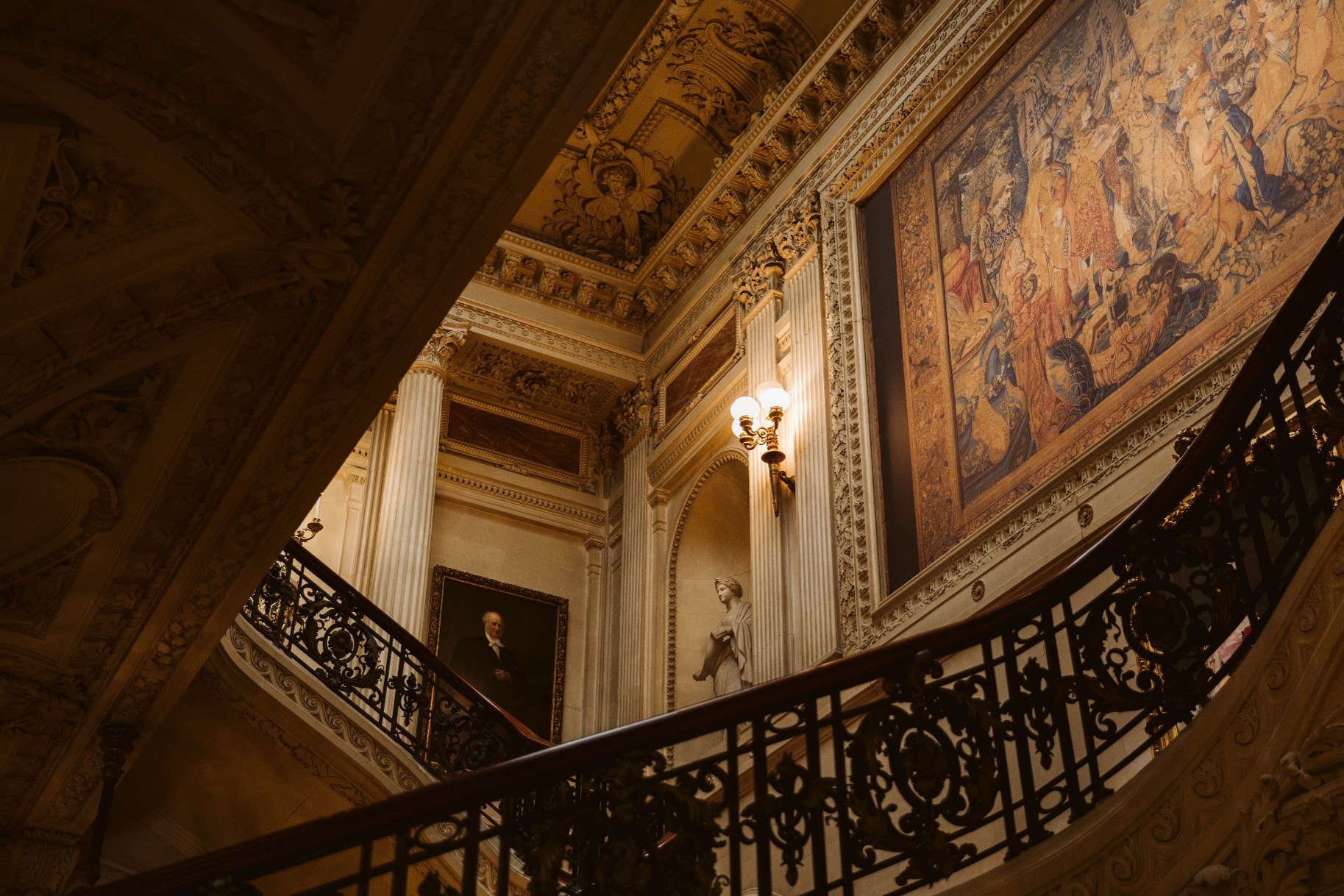Historic interior with antique architectural details, tapestry and portrait