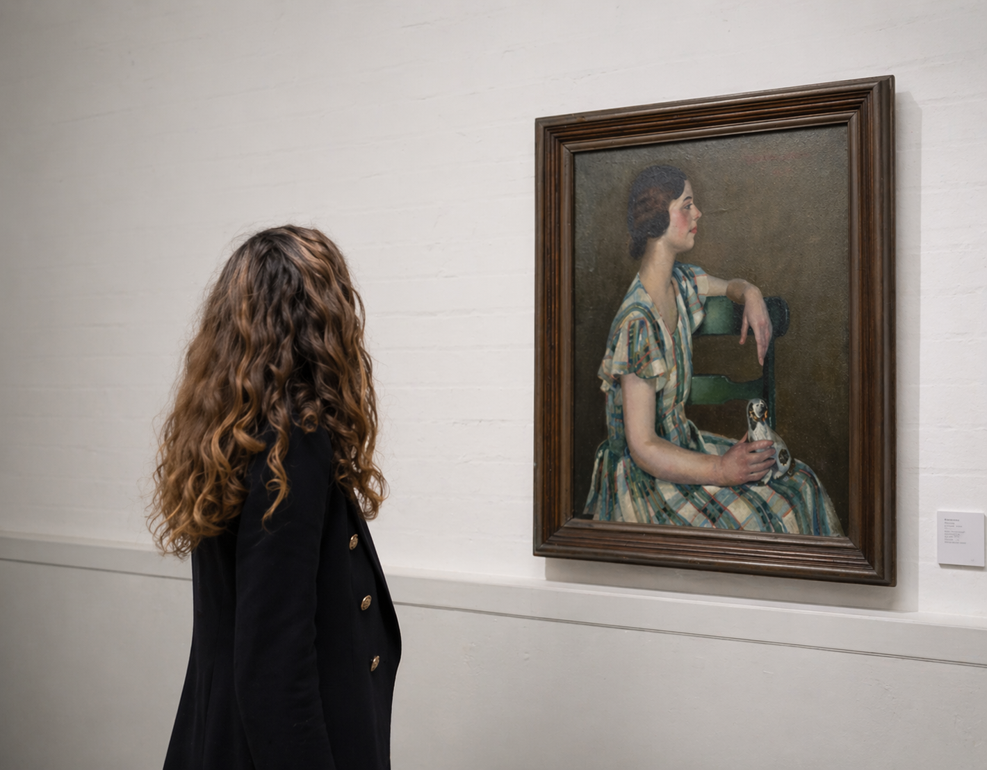 Painting specialist examining a framed portrait for valuation